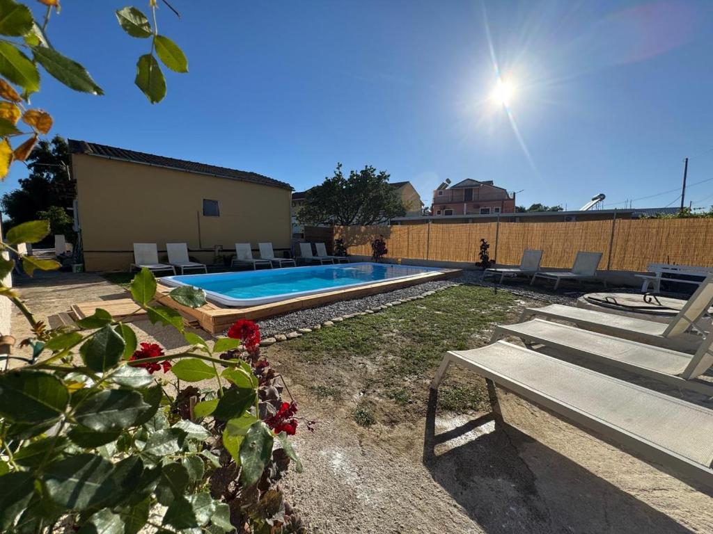 a swimming pool in a yard with a bench at Antilia Corfu 1 in Agios Georgios
