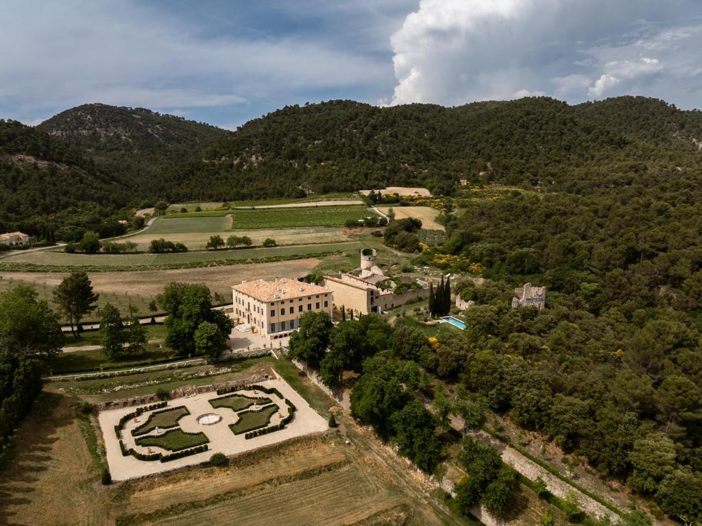 an aerial view of a building with trees and mountains at Château du Grand Pré in Vitrolles-en-Luberon