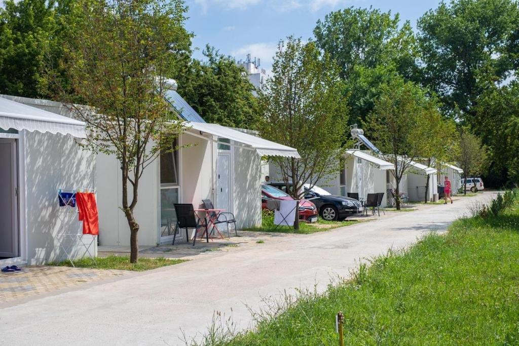a row of white houses on a street at Camping Bucuria Bungalow in Eforie Nord