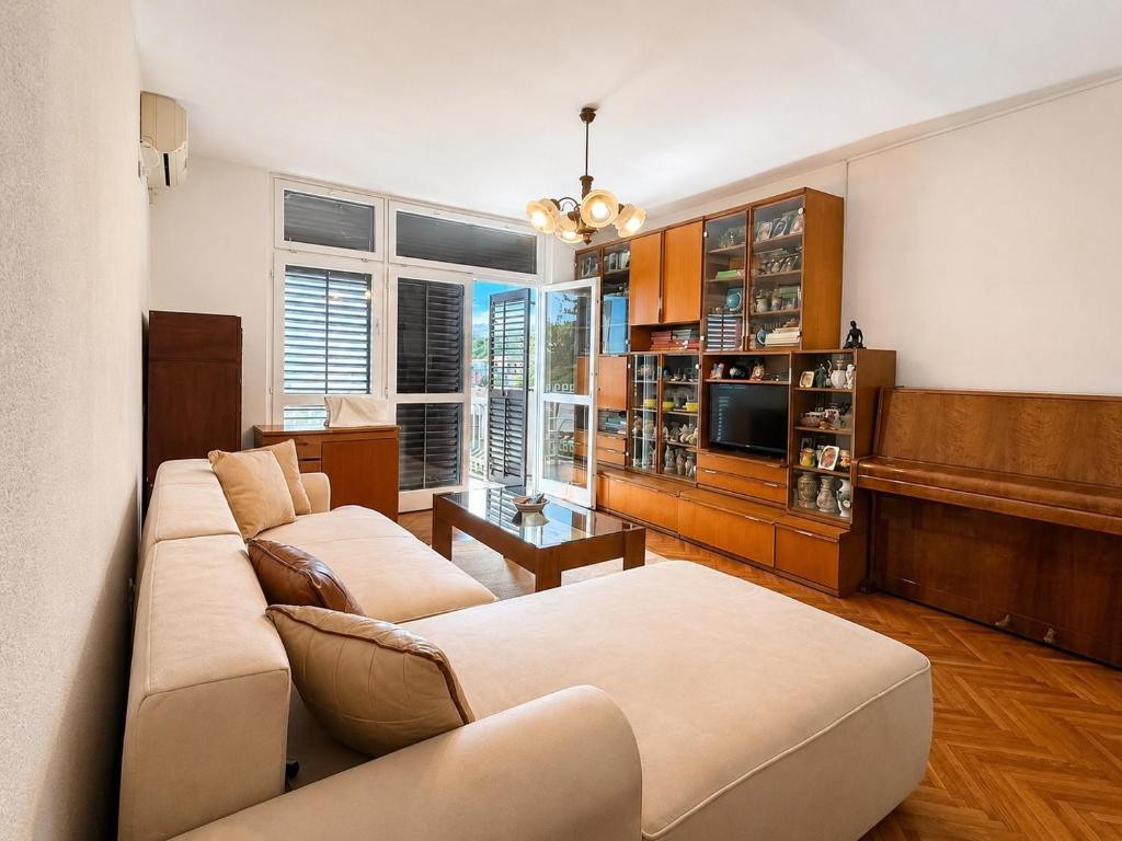 a living room with two couches and a television at Igalo Apartment in Igalo
