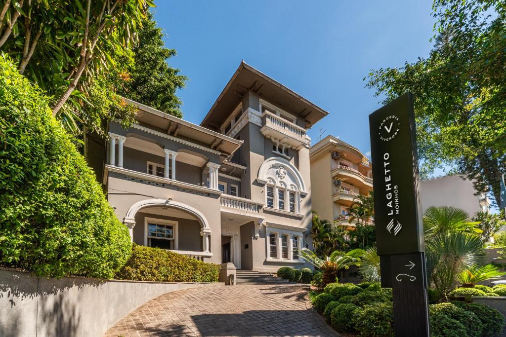 a house with a sign in front of it at Hotel Laghetto Moinhos in Porto Alegre