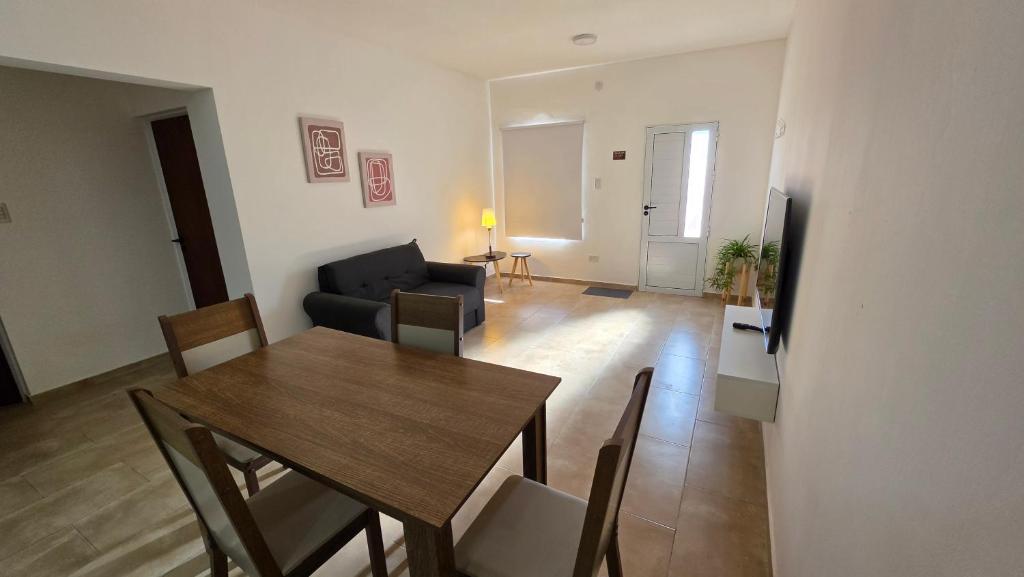 a living room with a table and a couch at Moderno apartamento en Colón in Colón Buenos Aires Province