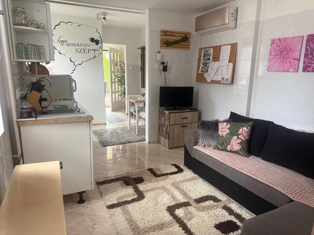 a living room with a couch and a kitchen at KiDo Apartman in Balatonberény