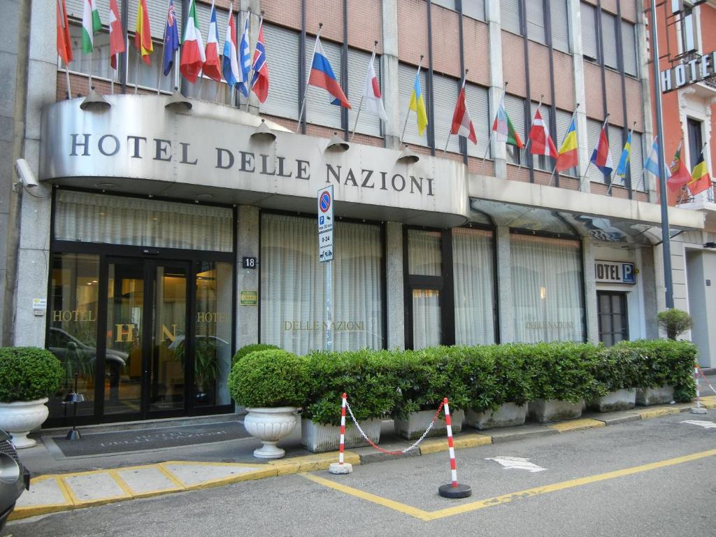 a hotel building with flags in front of it at Delle Nazioni Milan Hotel in Milan