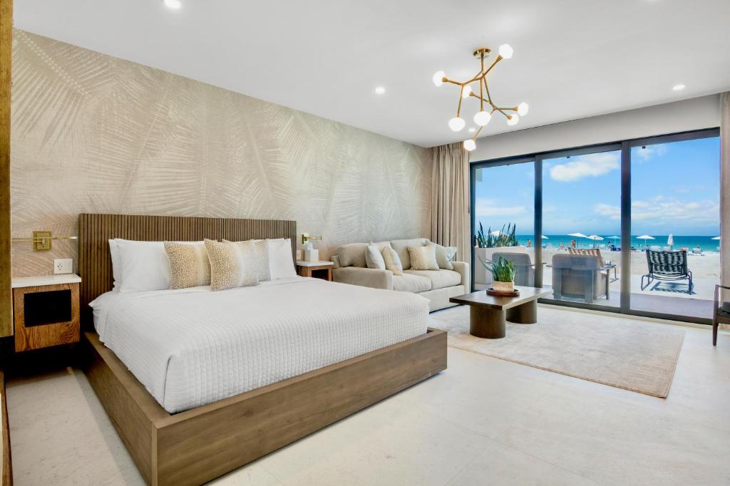 a bedroom with a bed and a view of the ocean at Bali Hai Beach Resort in Holmes Beach