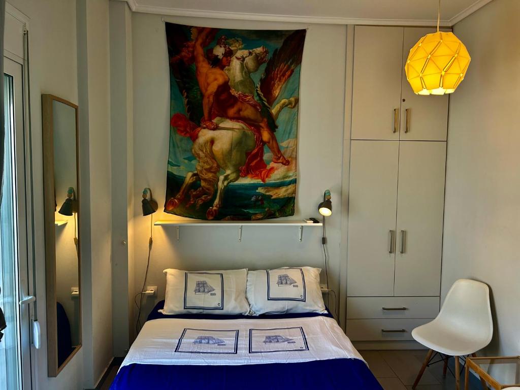 a bedroom with a bed with a painting on the wall at Royal Zea Suite 3 in Piraeus