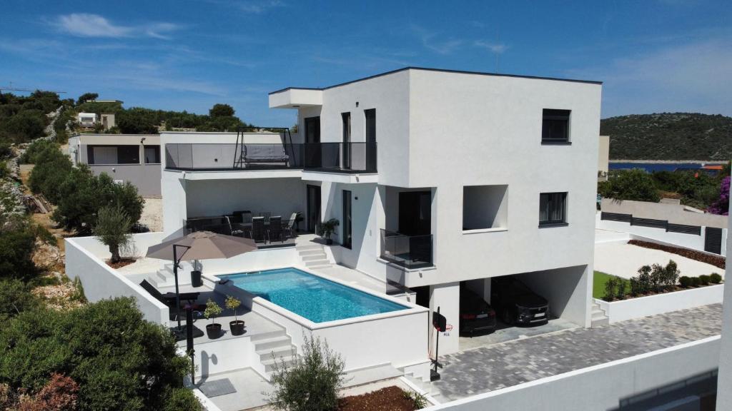 an aerial view of a white house with a swimming pool at Villa Omorfia - SEVID in Sevid