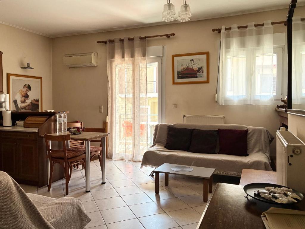 a living room with a couch and a table at Basis Apartment in Karpenisi