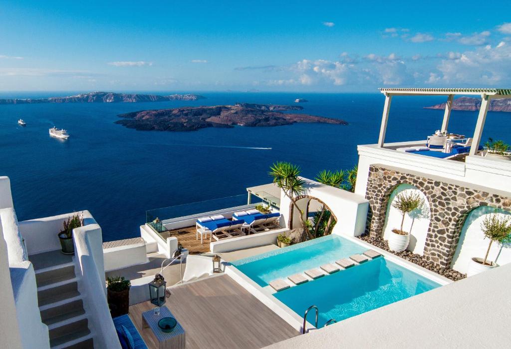 an image of a villa with a swimming pool at Iconic Santorini, a Boutique Cave Hotel in Imerovigli