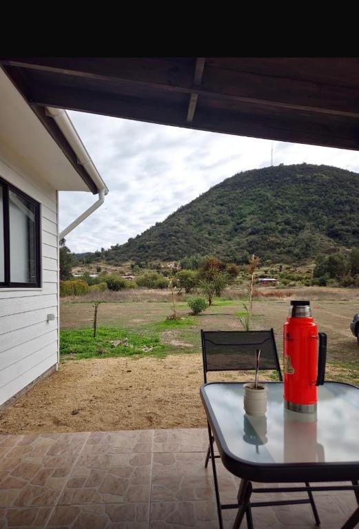 a table with a red fire hydrant on a patio at Refugio para 2 in Santa Cruz