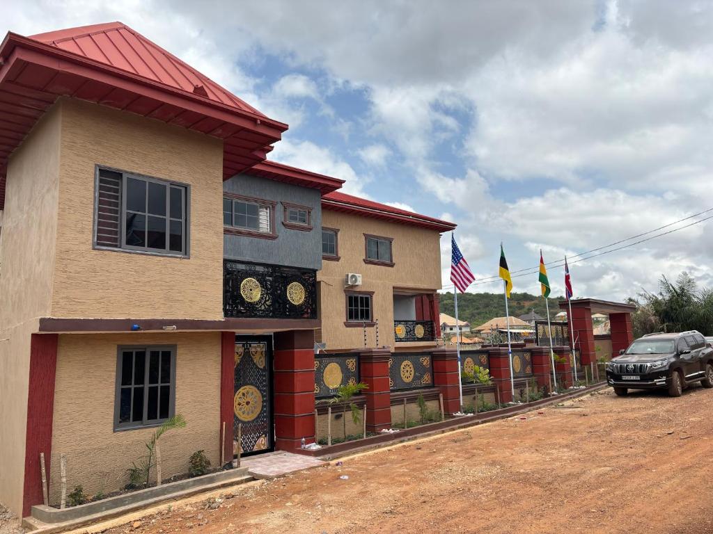a building with clocks on the side of it at KELNESSA Hotel in Obuassi