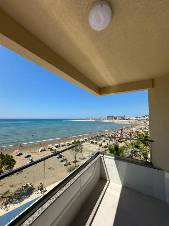 a balcony with a view of a beach and the ocean at Seaview Premium Apartment in Durrës