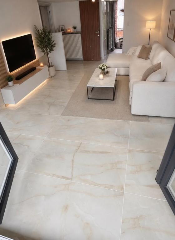 a living room with a large marble floor at 250m from Tommorowland in Boom