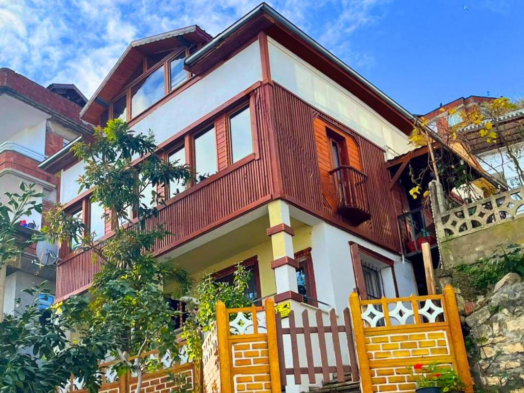 a house with a fence in front of it at Hacel's Stairs in Ordu