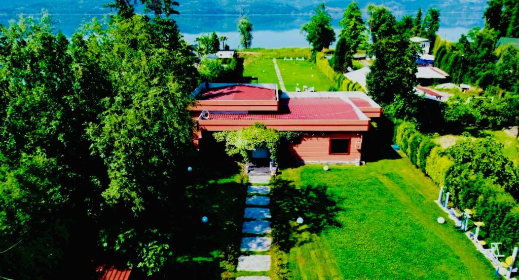 a house with a red roof in the middle of trees at Göl Konuk Evi in Sakarya