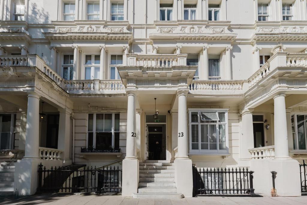 a white house with columns and a balcony at The Hyde Hotel in London