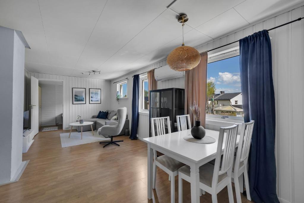 a dining room and living room with a table and chairs at Apartment in Tromsdalen in Tromsø