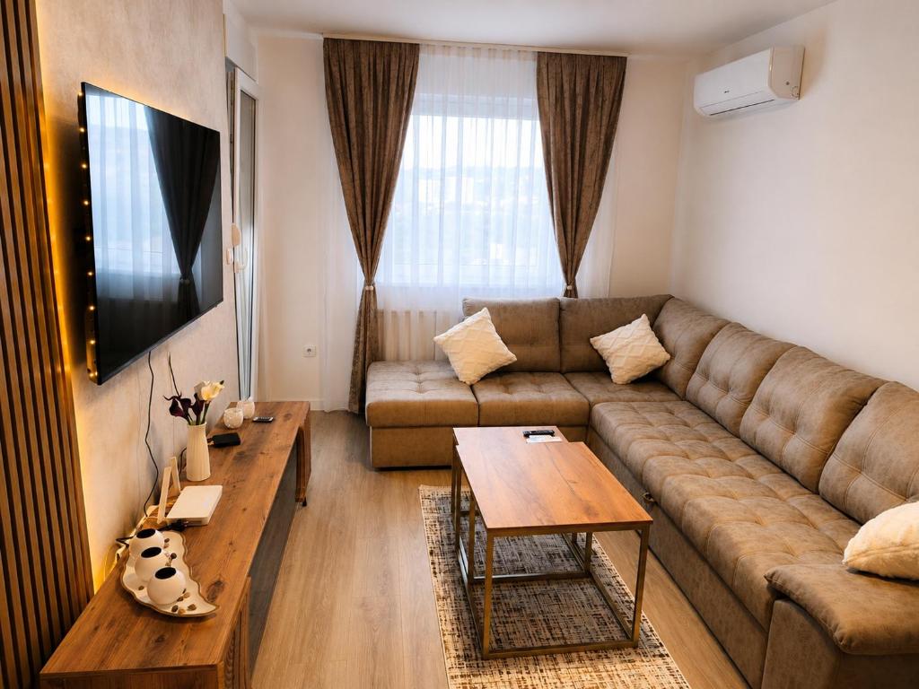 a living room with a couch and a table at Tulipan LUX in Doboj