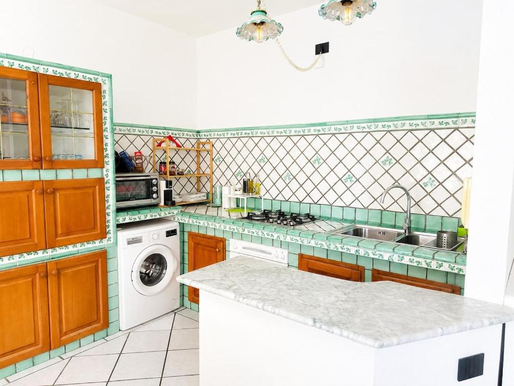 a kitchen with a sink and a stove top oven at Casa Mansi in Vietri sul Mare