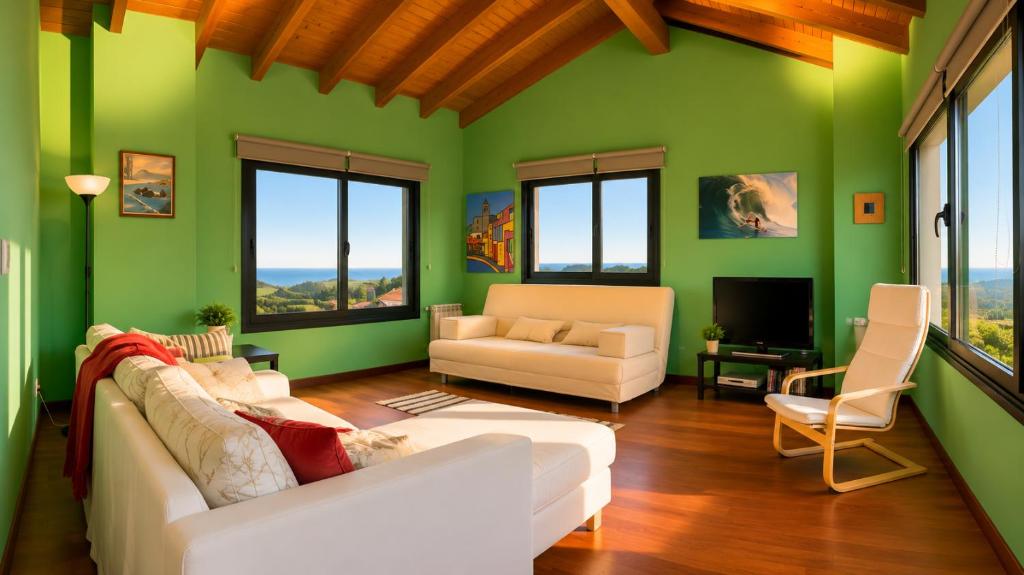 a living room with green walls and a white couch at La Cepada in Carrandi