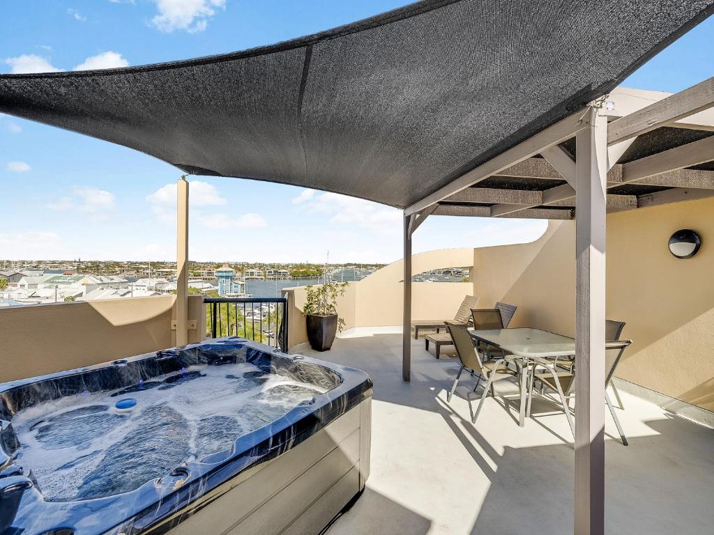 a hot tub on the balcony of a house at Nautilus Private Rooftop Spa in Mooloolaba