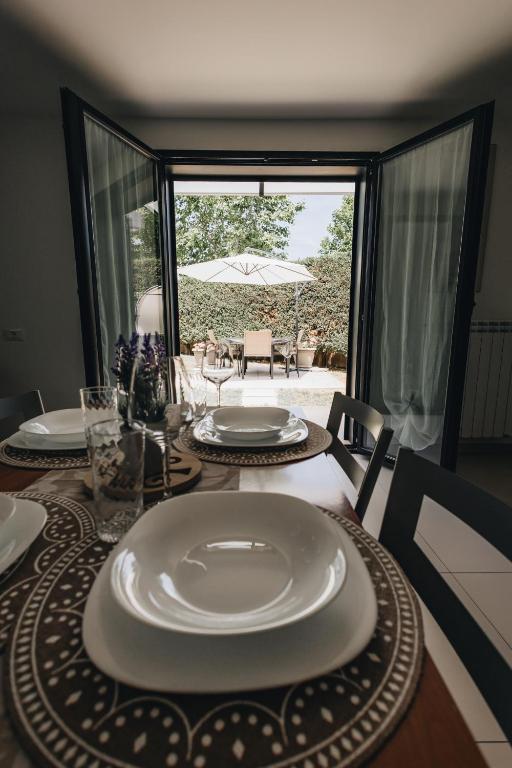 a dining room with a table with plates on it at Athena Garden House in Montesilvano