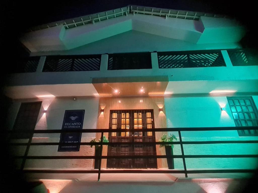 a view of a house with a balcony at night at Pousada Recanto da Enseada in Cabo de Santo Agostinho