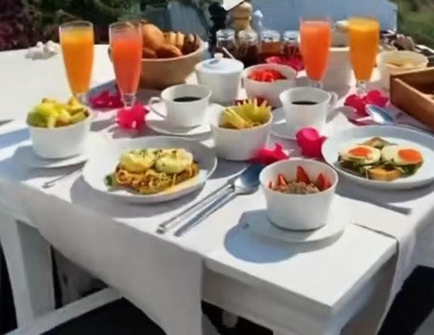 a white table with plates of food and drinks at Villa de luxe Palmarin in Palmarin
