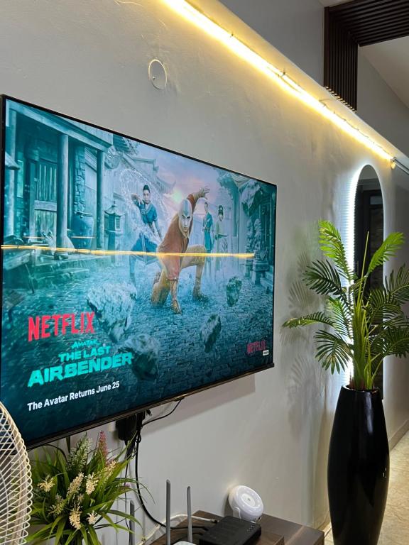a flat screen tv hanging on a wall at Silver Homes Empiror in Kampala