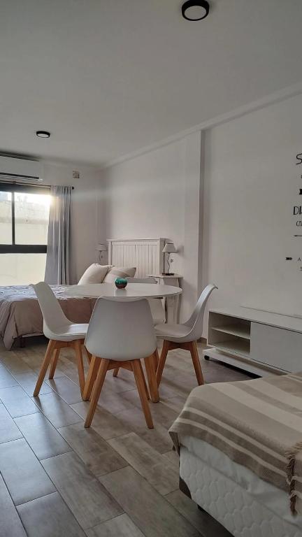 a bedroom with a table and chairs and a bed at Monoambiente 4 de enero in Santa Fe