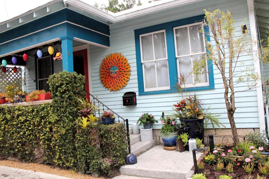 a blue house with flowers in front of it at Casa Del Sol Historic St Aug Hideaway in St. Augustine