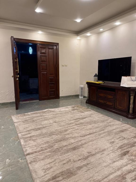 a living room with a flat screen tv and a large rug at 3 BR apartment, fully renovated in Amman