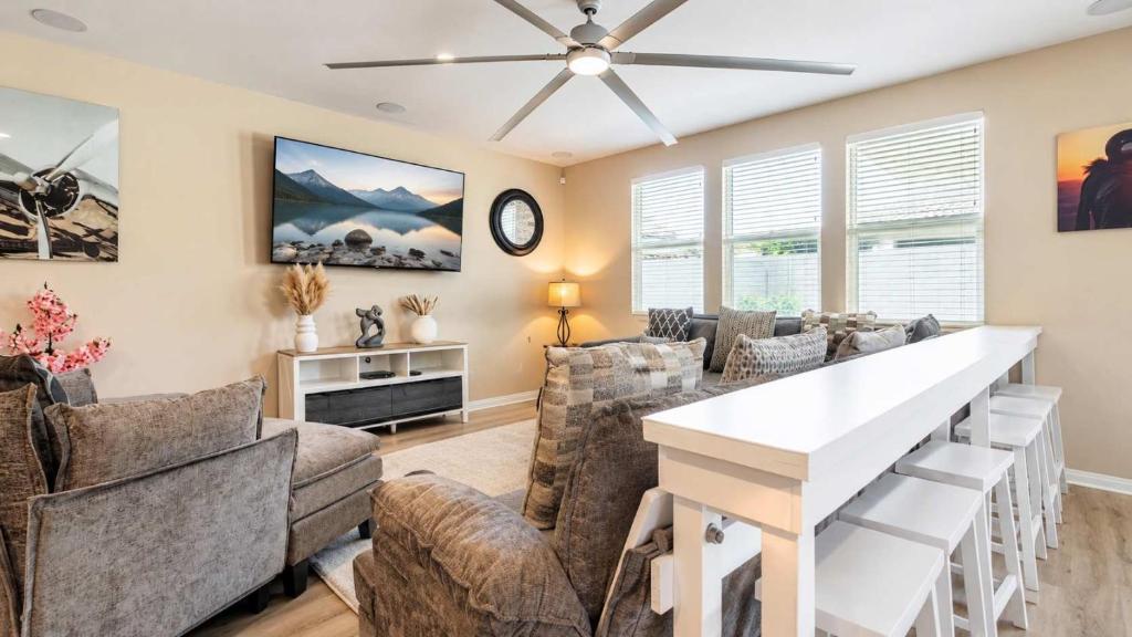 a living room with furniture and a ceiling fan at Temecula Valley 4BR - Pool Table & Fenced Yard in Winchester