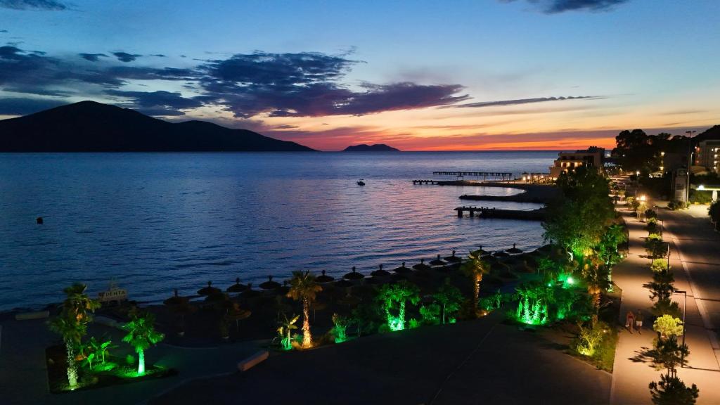 a view of a beach at night with the ocean at Hotel Divers in Vlorë