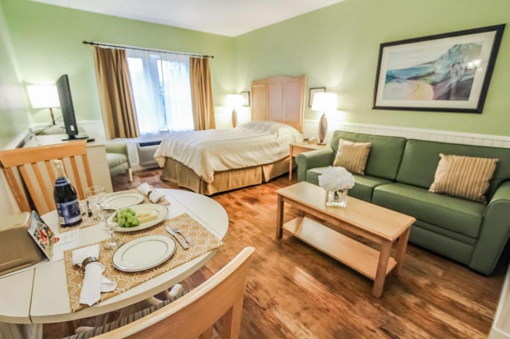 a hotel room with a couch and a bed at Holly Tree Resort - Studio in Yarmouth