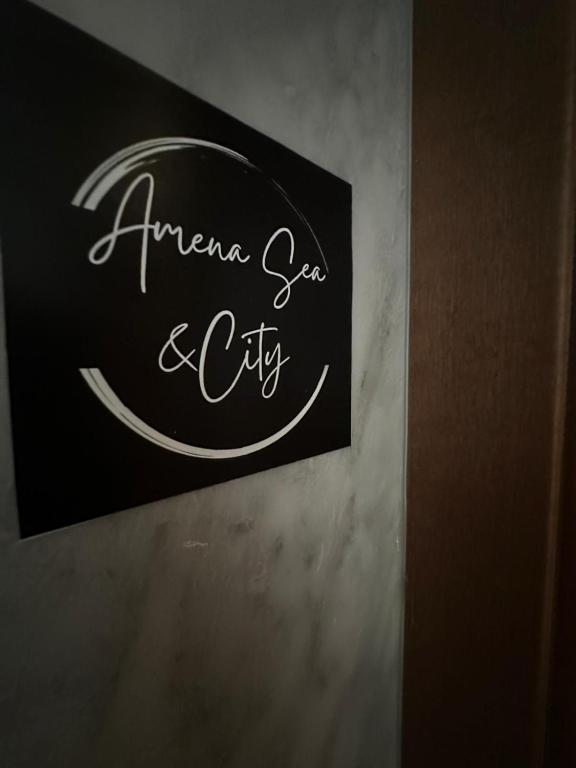 a sign on a wall that reads amen ego and city at Amena Sea & City in Brindisi