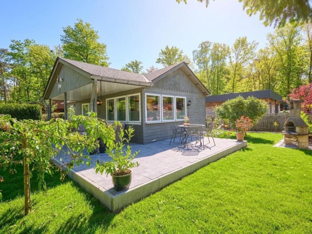 a house with a patio in the yard at Barri in Zutendaal