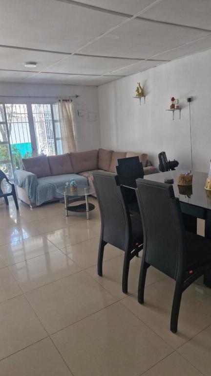 a living room with a couch and a table and chairs at Villa Salguero in Gaira