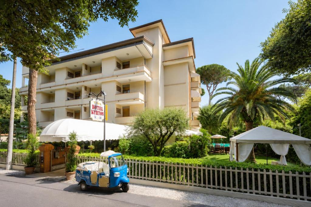 a small blue car parked in front of a building at Hotel Kyrton in Forte dei Marmi