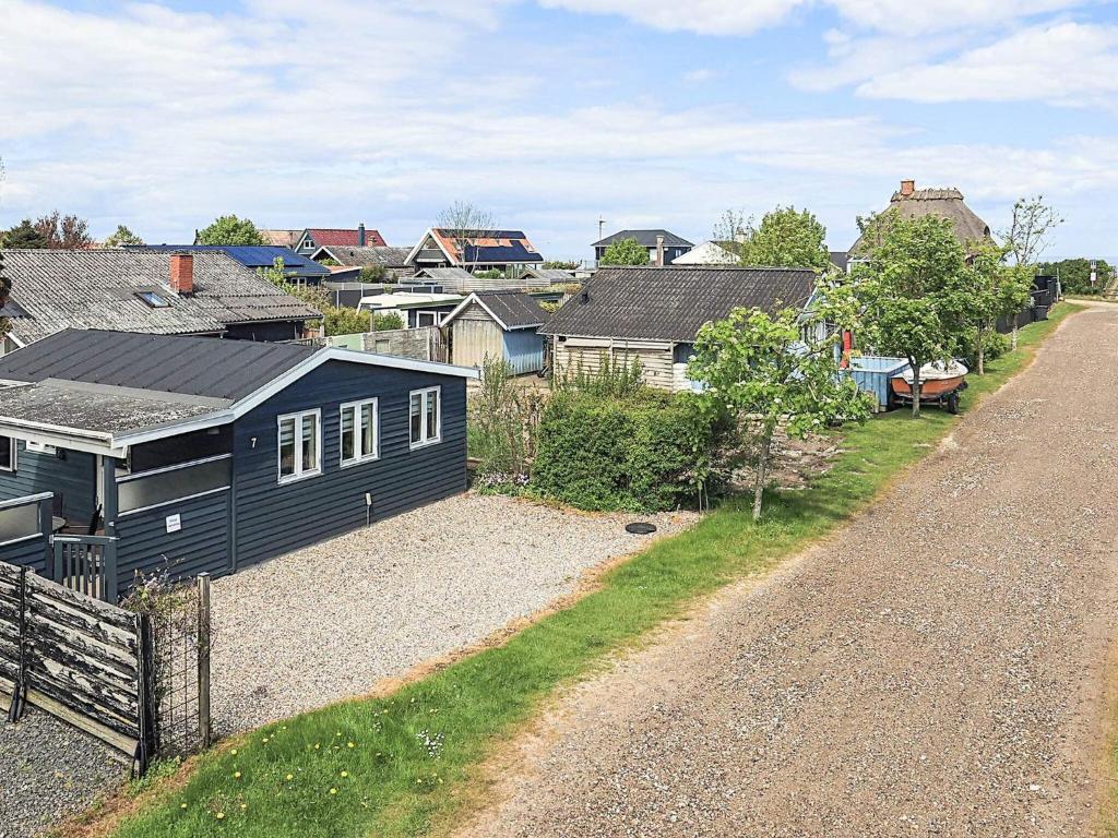 a blue house sitting on the side of a road at 2 person holiday home in Otterup in Otterup