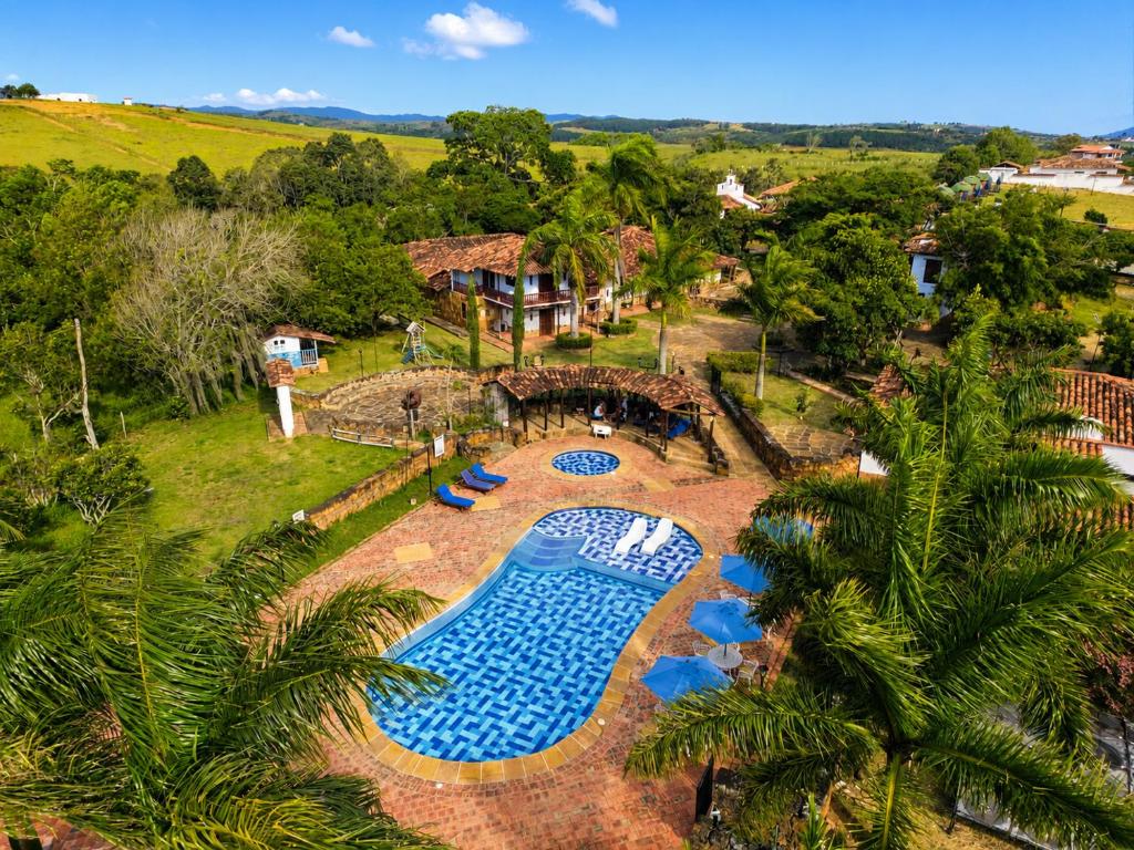 an overhead view of a swimming pool with blue chairs at Hotel Finca Buenos Aires Barichara in Barichara