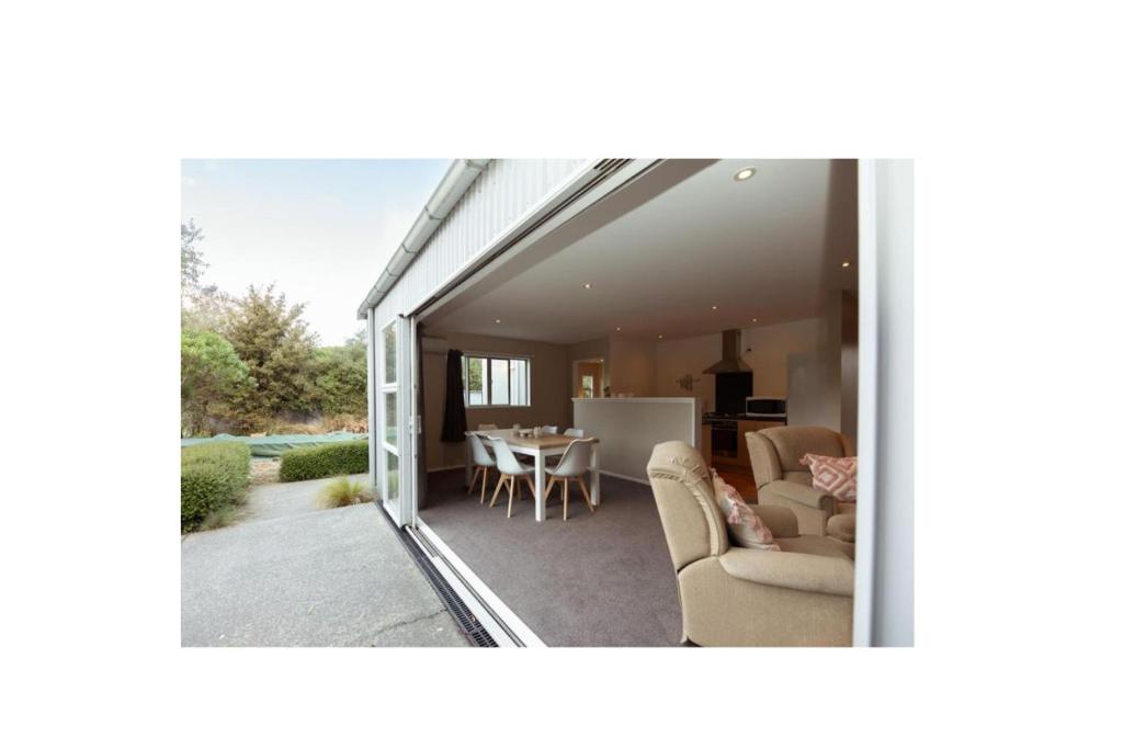 a view of a living room and dining room from inside a house at Alpine Nook in Methven's Heart, Walk to Town in Methven