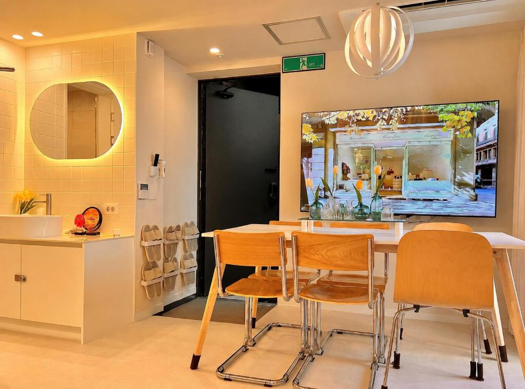 a kitchen with a table and chairs and a mirror at Stay BUT SEONGSU in Seoul
