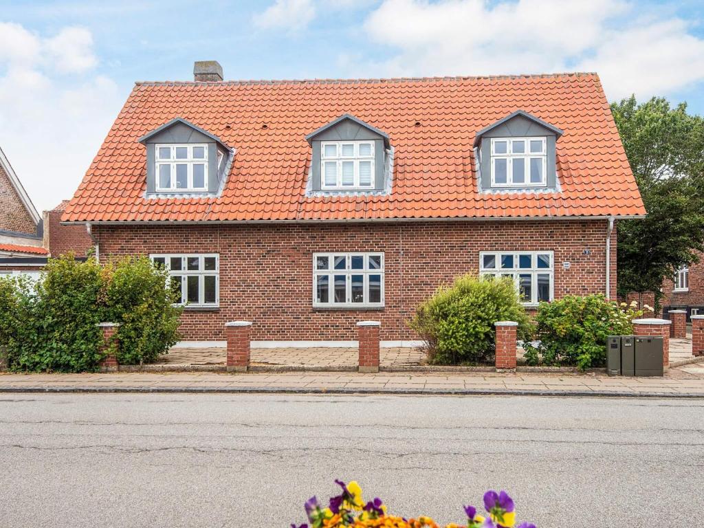 a red brick house with an orange roof at Charming Stay in Ringkobing in Ringkøbing