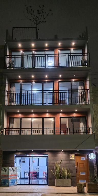 a large building with a balcony on top of it at Lima Airport Hostel - FREE AIRPORT PICK UP in Lima