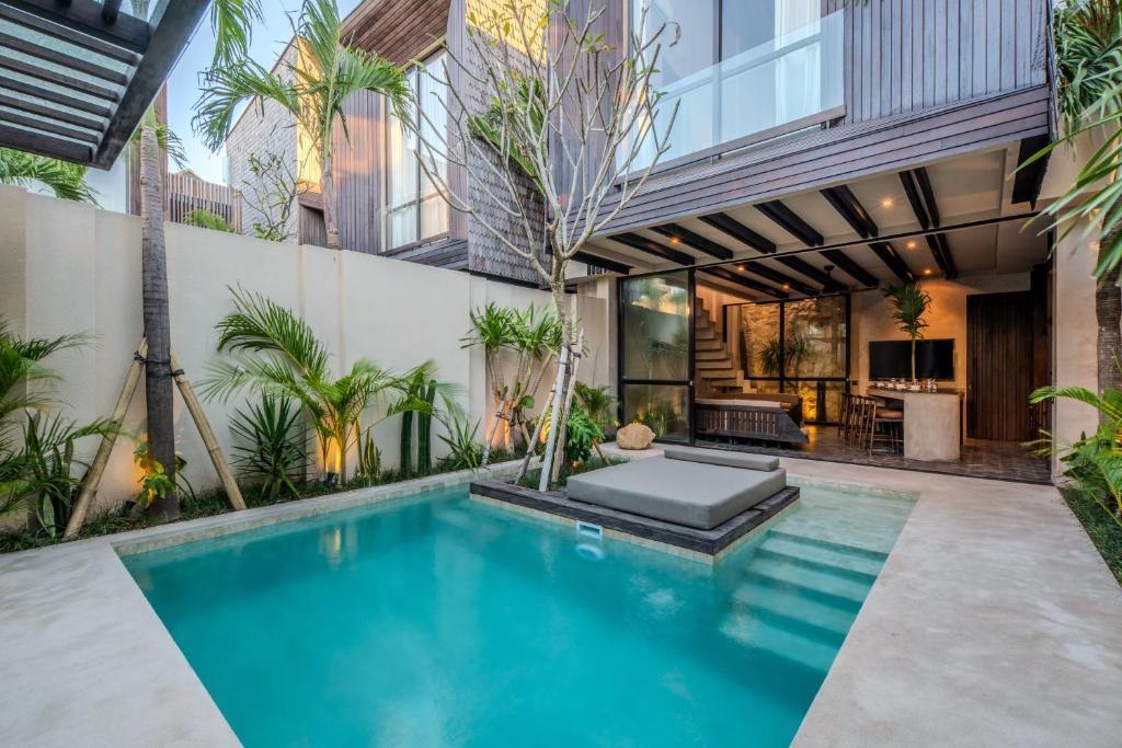 an indoor swimming pool in the middle of a house at The Sirocco Villas Bingin by Sandara in Bingin Beach