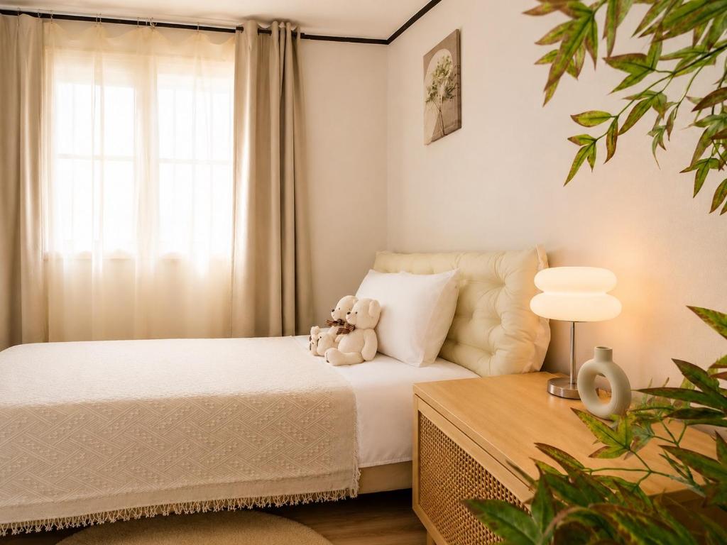 a teddy bear sitting on a bed in a bedroom at 수원 화서역 편한 집 in Suwon