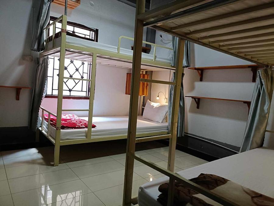 two bunk beds in a room with a window at City Backpackers Hostel in Luang Prabang