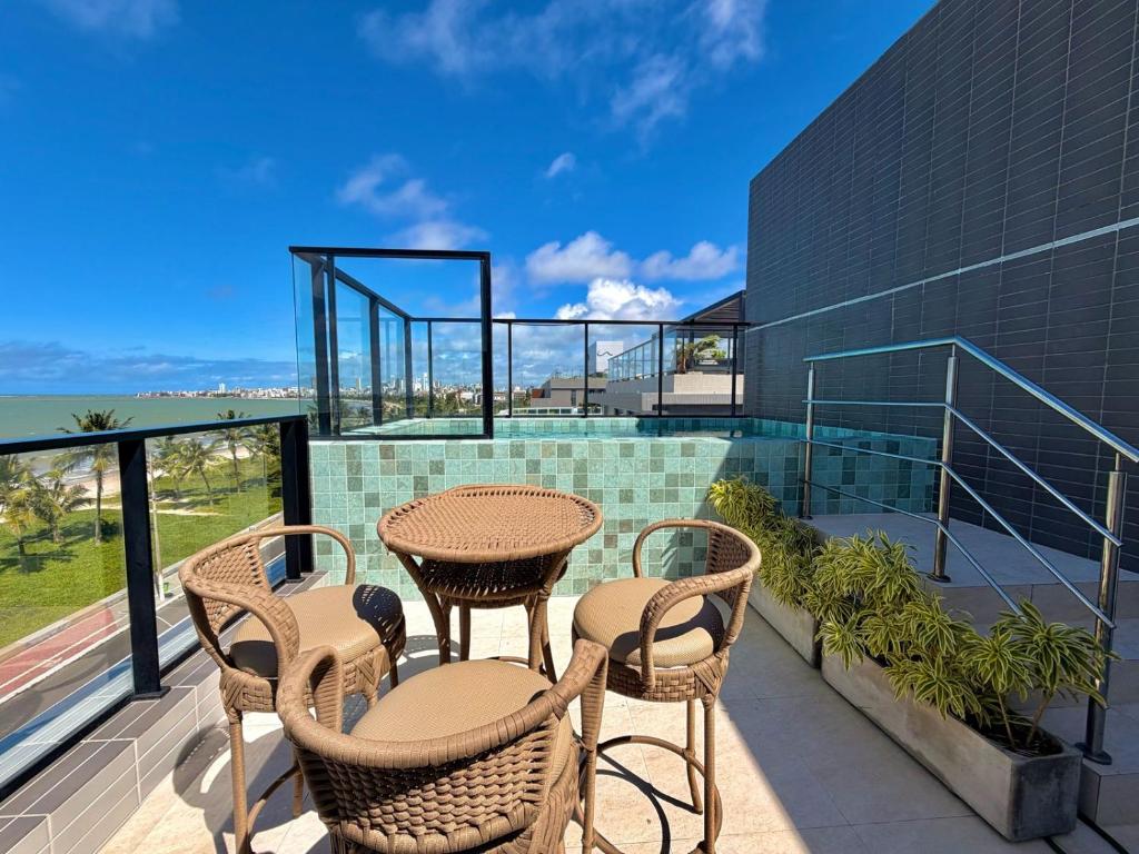 a patio with a table and chairs on a balcony at G5 Beach Flat Intermares 304 in Cabedelo