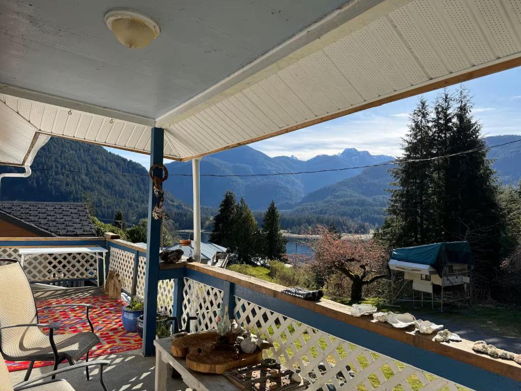 a balcony with a view of the mountains at Husie by die see in Tahsis